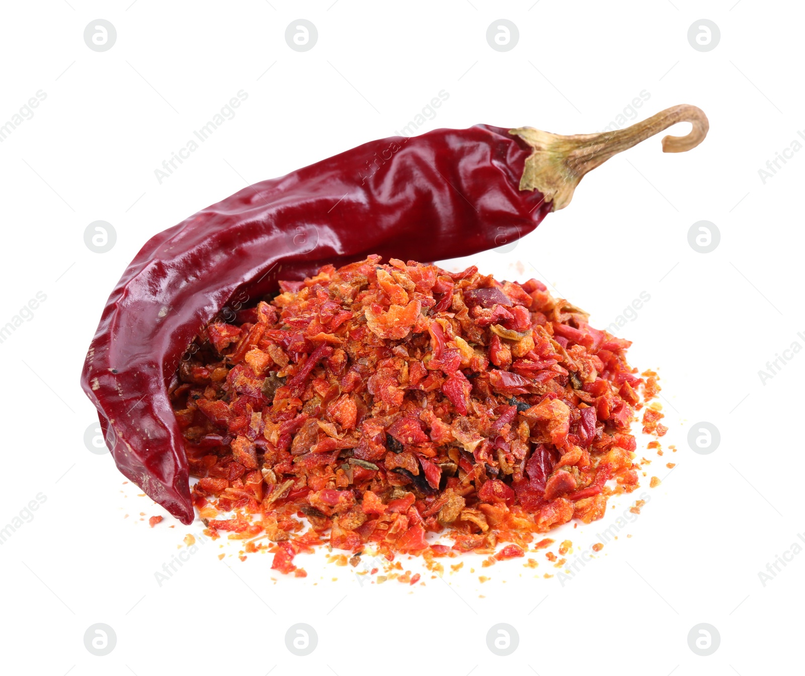 Photo of Aromatic spice. Pile of red chili pepper flakes and pod isolated on white