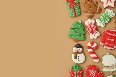 Different Christmas gingerbread cookies on brown background, flat lay. Space for text