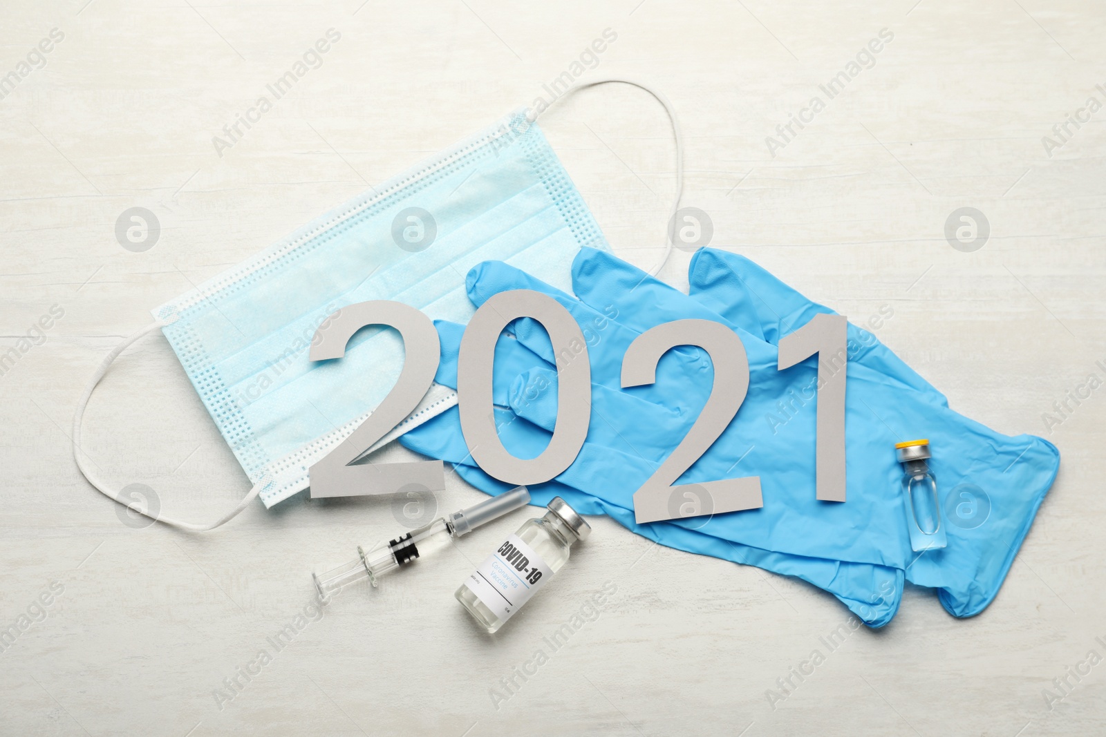 Photo of Flat lay composition with coronavirus vaccine and number 2021 on white background