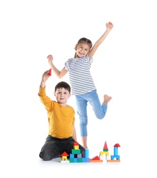 Photo of Cute children playing with colorful blocks on white background