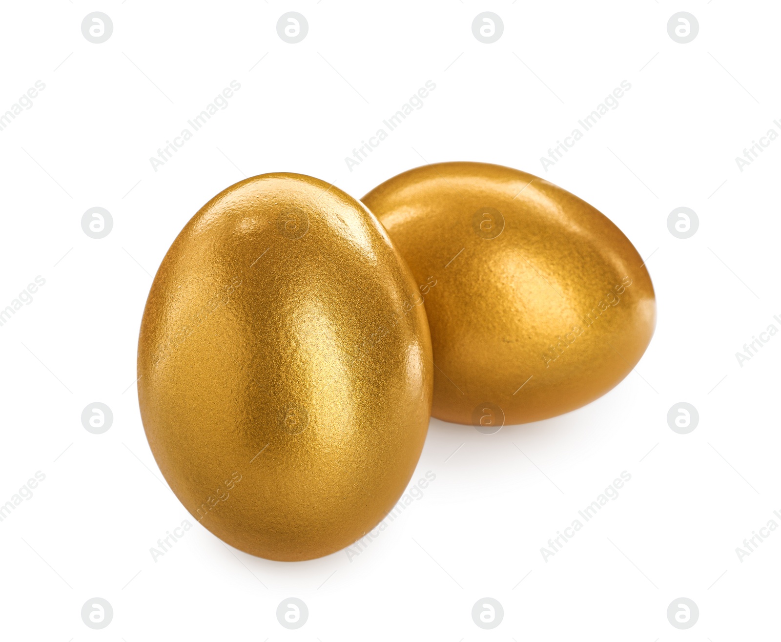 Photo of Two shiny golden eggs on white background