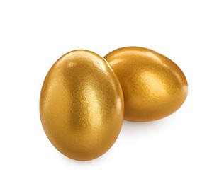 Two shiny golden eggs on white background