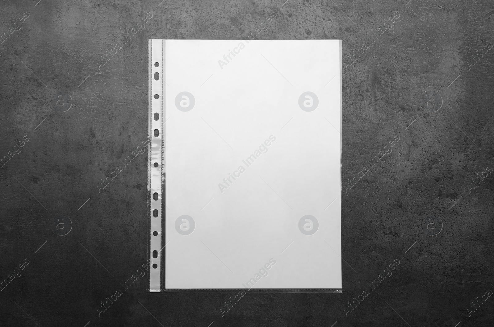 Photo of Punched pocket with paper sheet on grey background top view