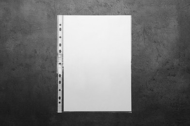 Photo of Punched pocket with paper sheet on grey background top view