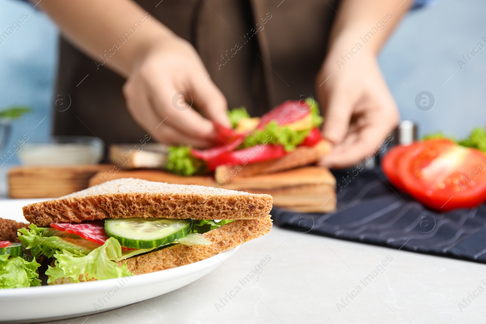 Photo of Tasty sandwich on light grey table, closeup