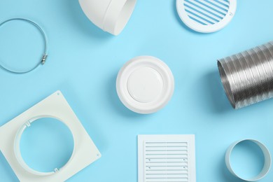 Photo of Parts of home ventilation system on light blue background, flat lay