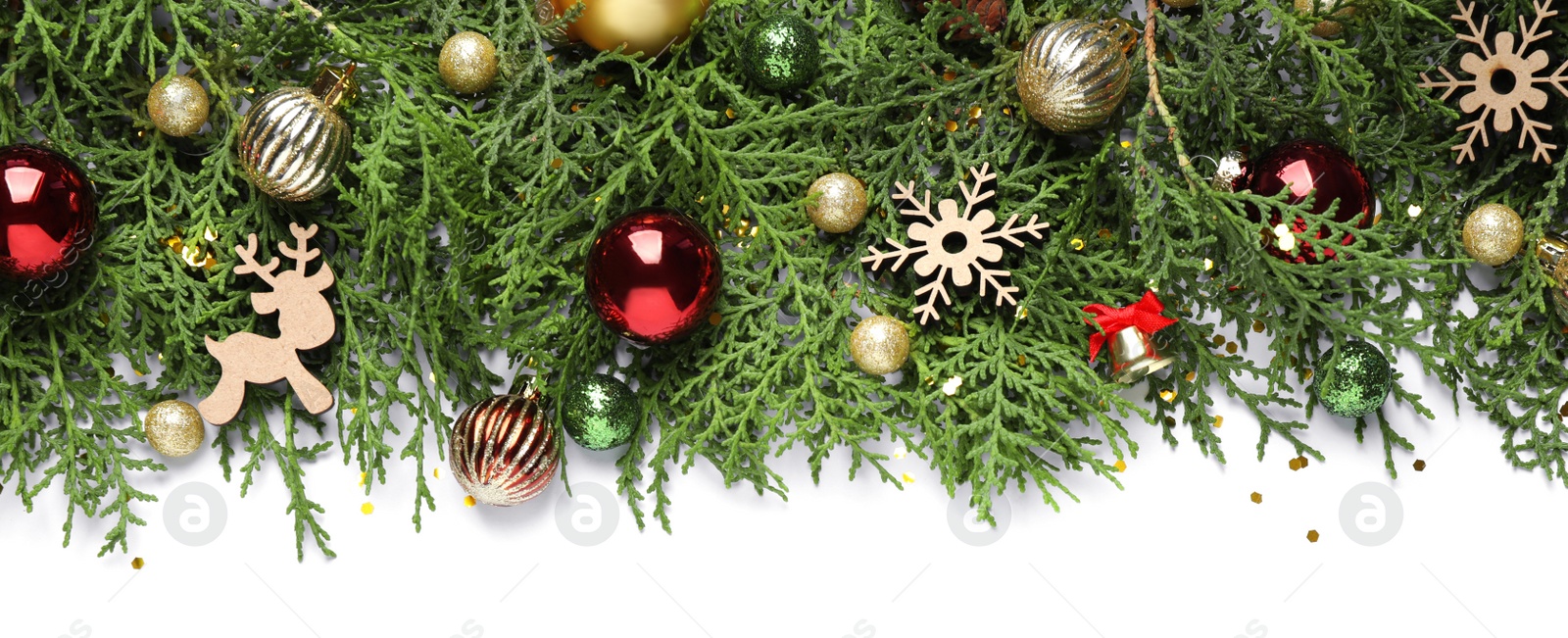 Photo of Thuja branches with Christmas decorations on white background, flat lay