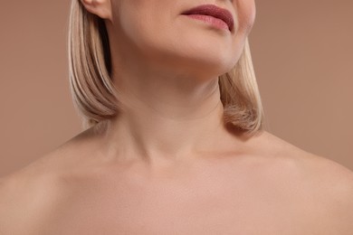 Woman with healthy skin on beige background, closeup