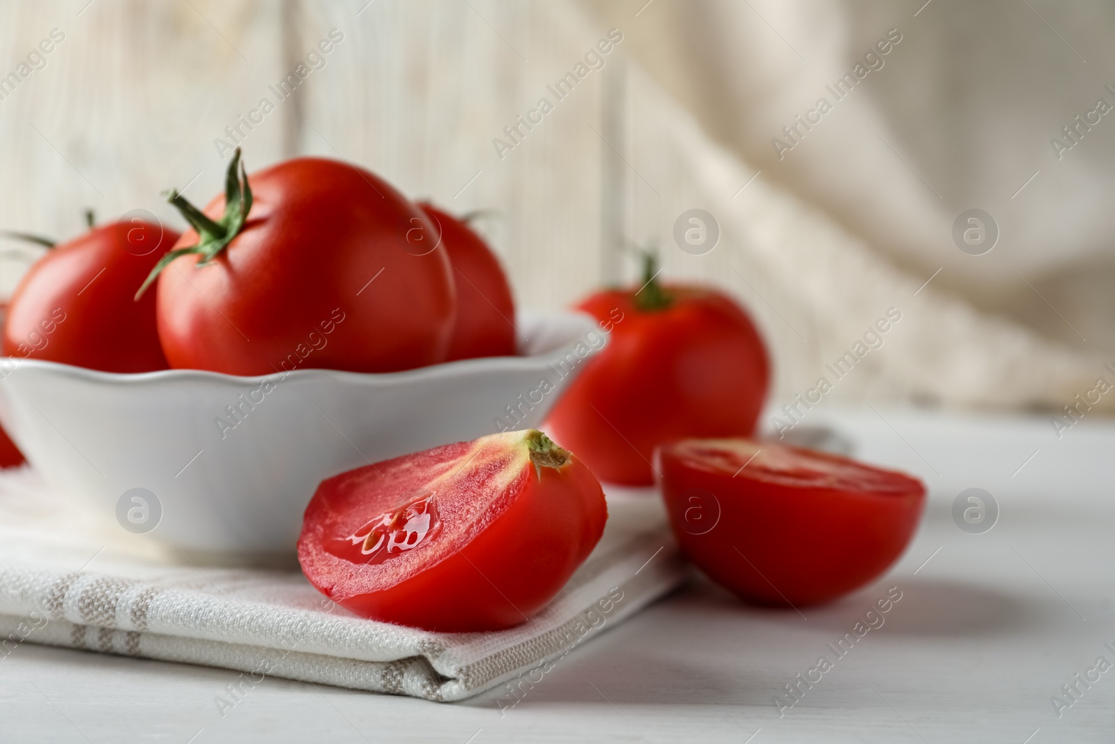 Photo of Fresh ripe tomatoes on white wooden table, closeup