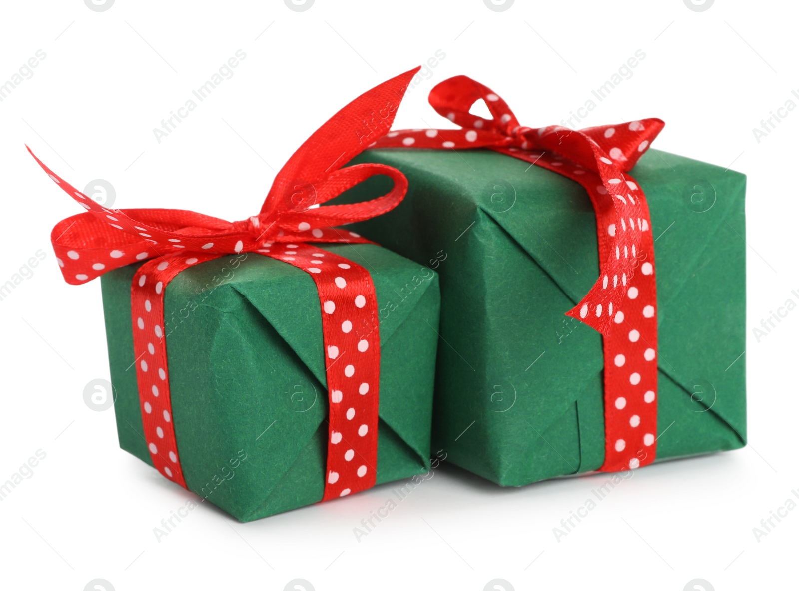 Photo of Christmas gift boxes decorated with red bows on white background