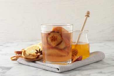 Photo of Delicious compote and ingredients on white marble table