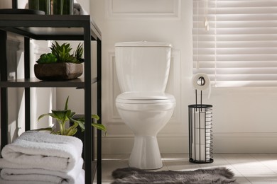Photo of Modern toilet bowl in comfortable restroom. Interior design