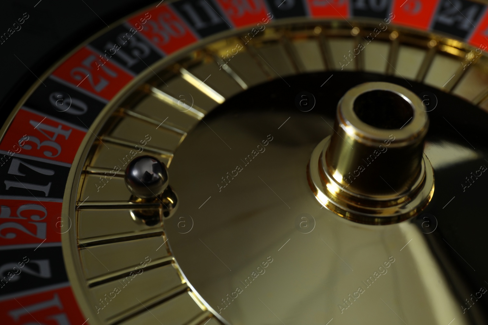 Photo of Roulette wheel with ball, closeup. Casino game