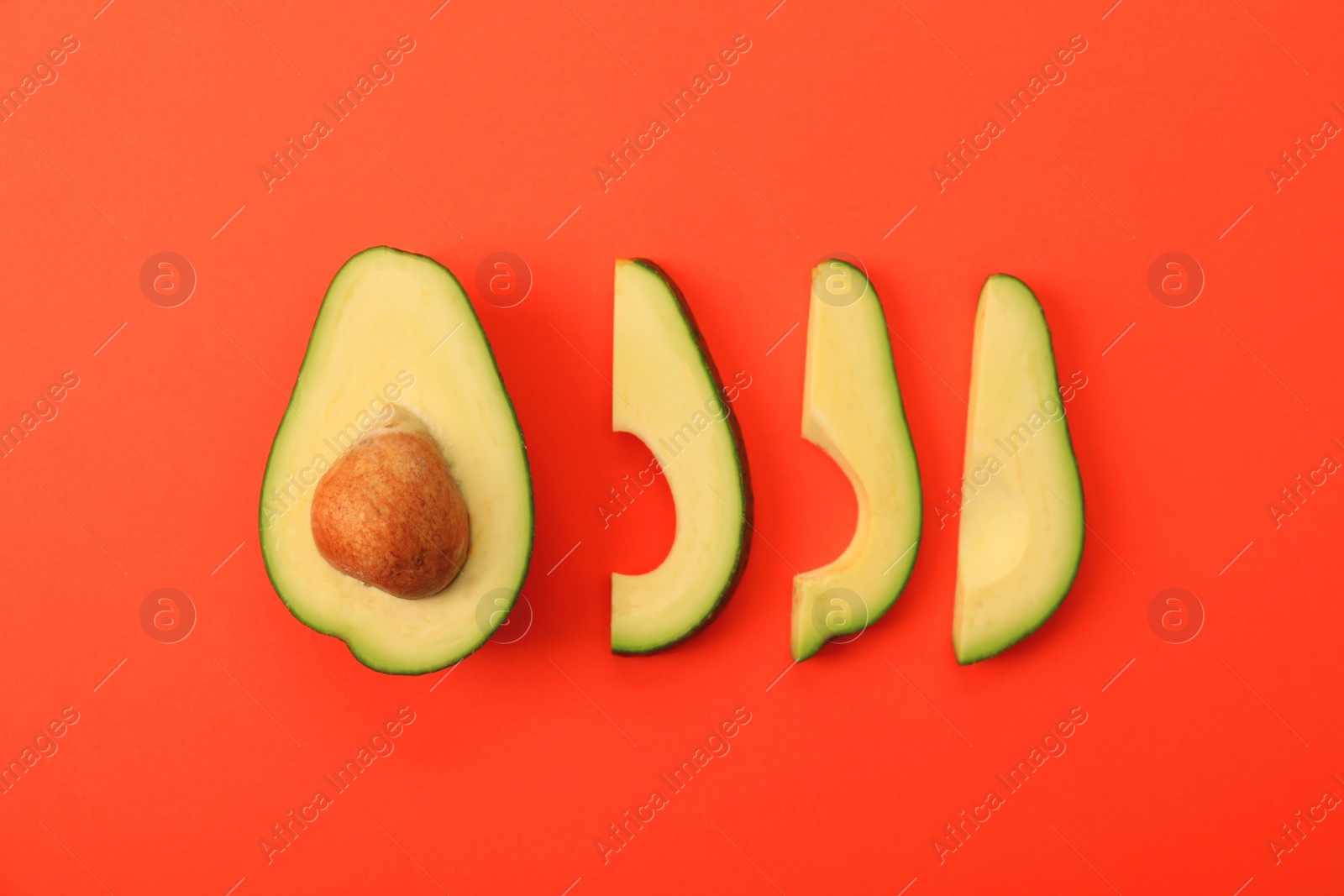 Photo of Flat lay composition with avocado slices on red background