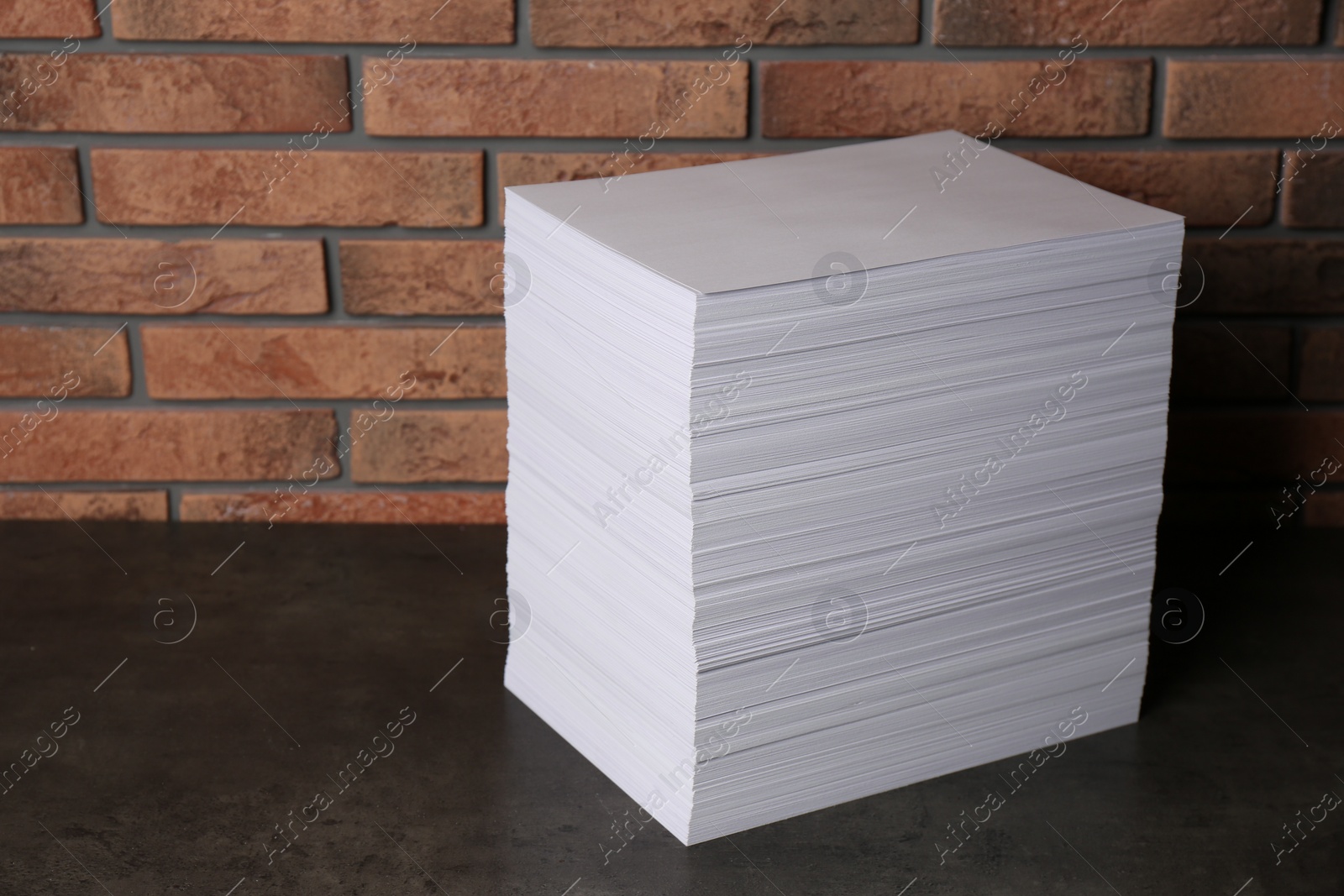 Photo of Stack of paper sheets on black table