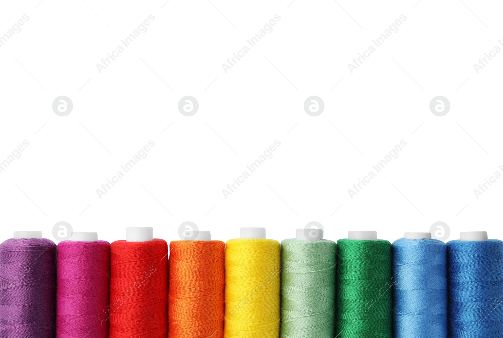 Photo of Different colorful sewing threads on white background, top view