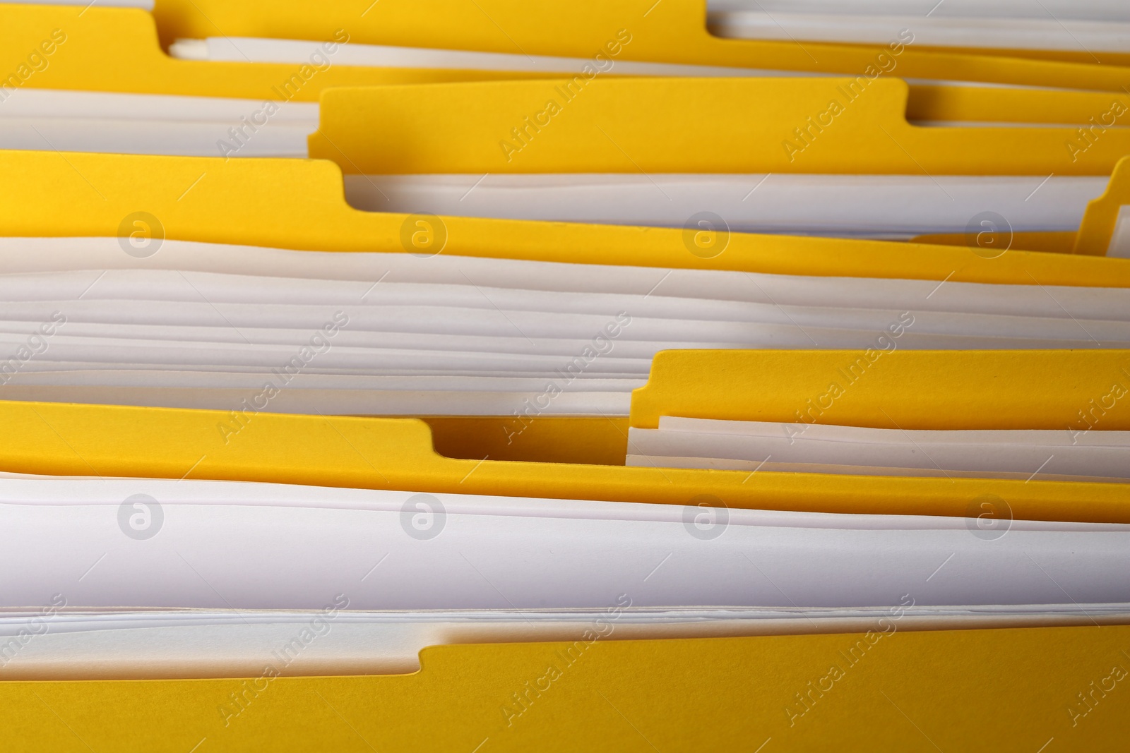 Photo of Many yellow files with documents as background, closeup
