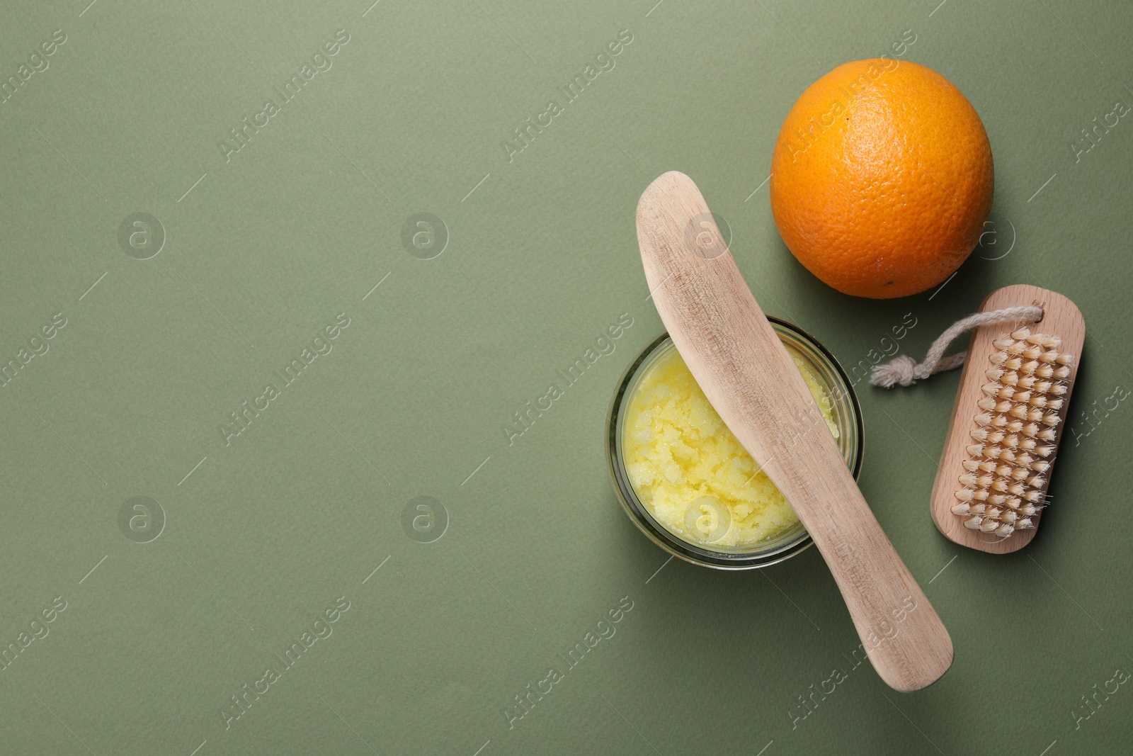 Photo of Flat lay composition with natural body scrub on olive background, space for text. Anti cellulite treatment