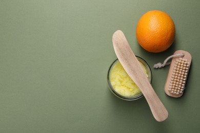 Photo of Flat lay composition with natural body scrub on olive background, space for text. Anti cellulite treatment