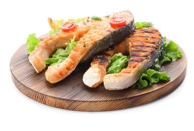 Photo of Wooden board with tasty salmon steak on white background