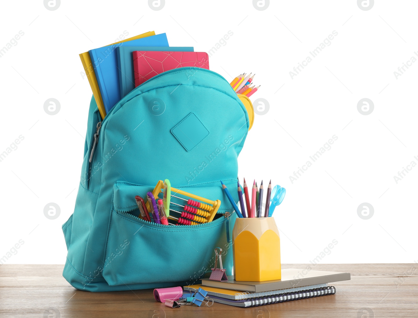 Photo of Bright backpack with school stationery on white background