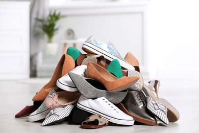 Photo of Pile of female shoes on floor indoors