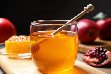 Photo of Honey, apples and pomegranate on table. Rosh Hashanah holiday