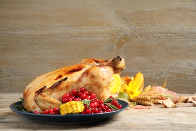 Photo of Plate with delicious turkey on wooden background, space for text. Happy Thanksgiving day