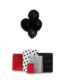 Black Friday concept. Bunch of balloons and shopping bags on white background