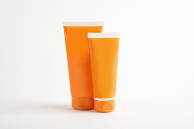 Tubes with sun protection body cream on white background