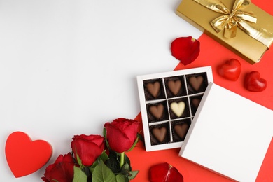 Flat lay composition with heart shaped chocolate candies on color background, space for text. Valentine's day celebration