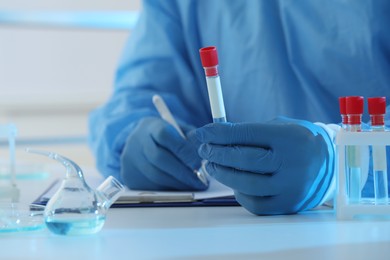 Photo of Scientist working at table, closeup. Medical research