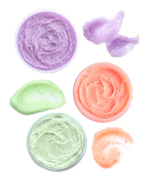 Set with different samples and containers of natural scrubs on white background, top view  