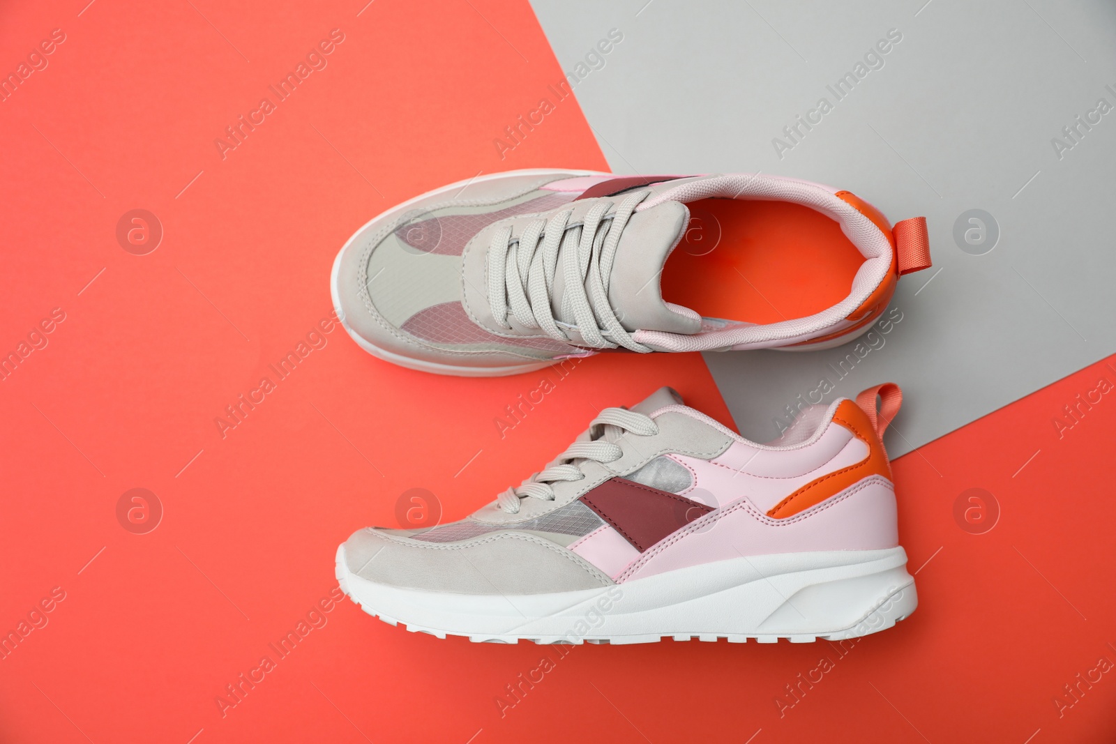 Photo of Stylish women's sneakers on color background, top view