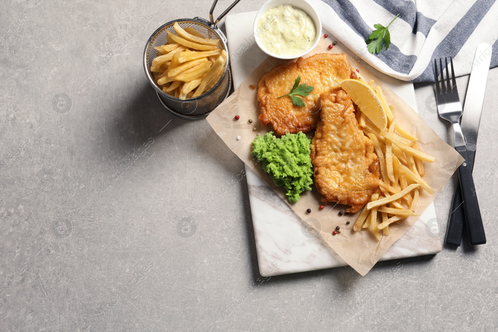 Photo of British traditional fish and potato chips on table, top view with space for text