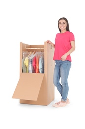 Photo of Young woman near wardrobe box on white background