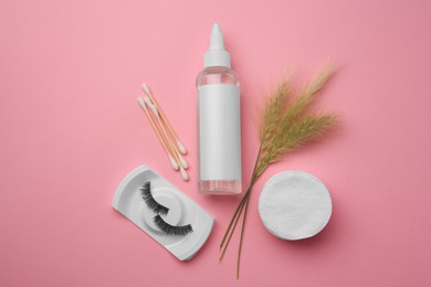 Flat lay composition with makeup remover and false eyelashes on pink background