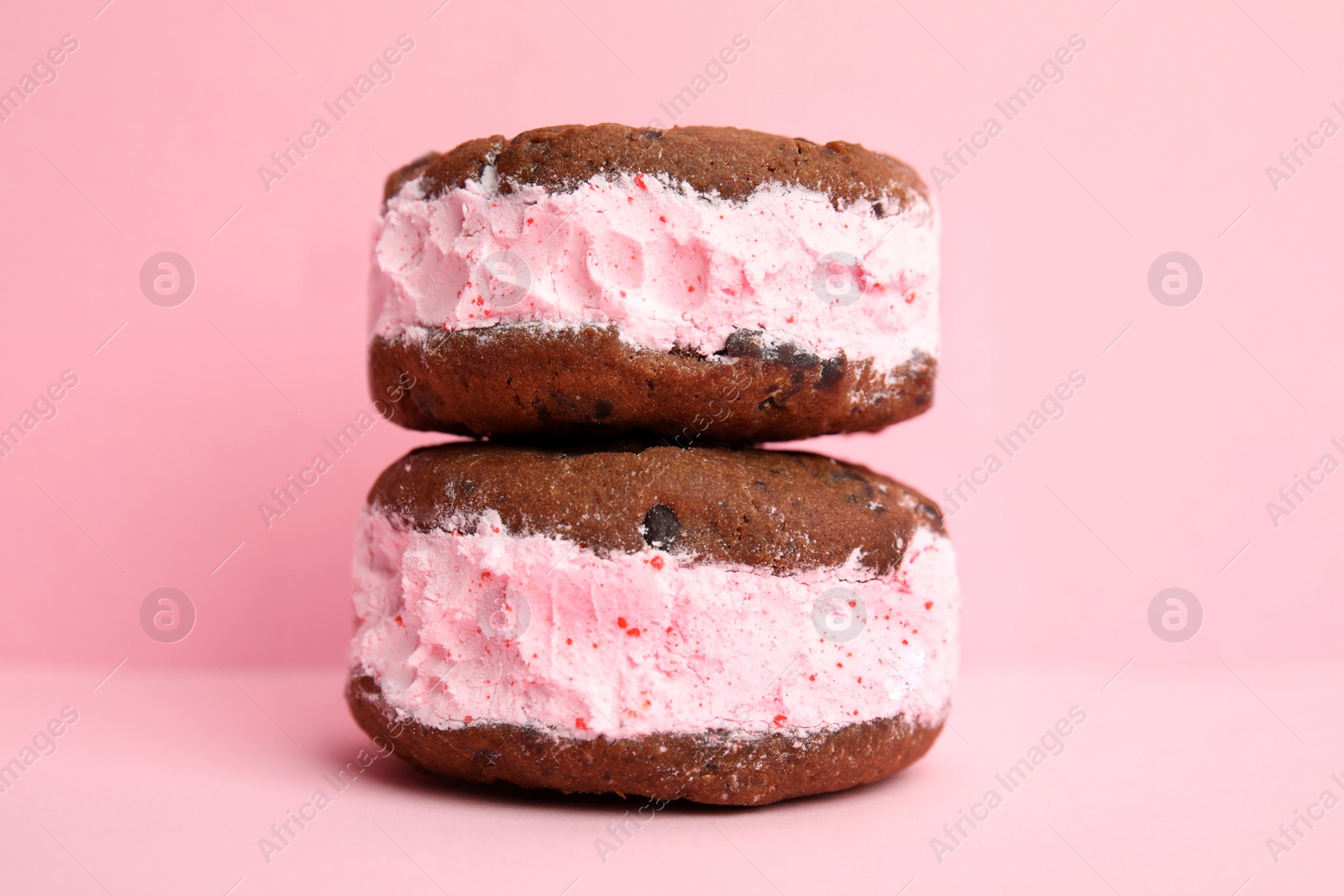 Photo of Sweet delicious ice cream cookie sandwiches on color background