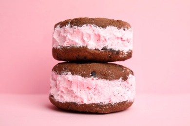 Photo of Sweet delicious ice cream cookie sandwiches on color background