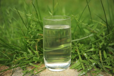 Photo of Pouring fresh water on stone surface outdoors