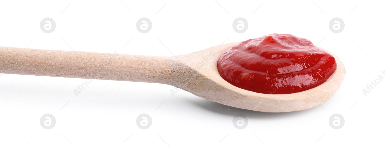 Photo of Spoon with tasty ketchup isolated on white. Tomato sauce