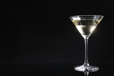 Photo of Martini cocktail on dark background. Space for text