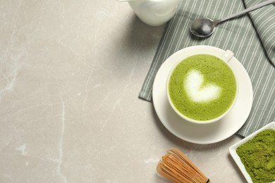 Flat lay composition with tasty matcha latte on light gray marble table, space for text