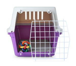 Violet pet carrier with toy isolated on white