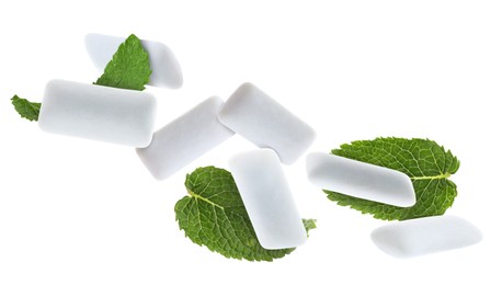 Image of Fresh mint leaves and chewing gum pads falling on white background