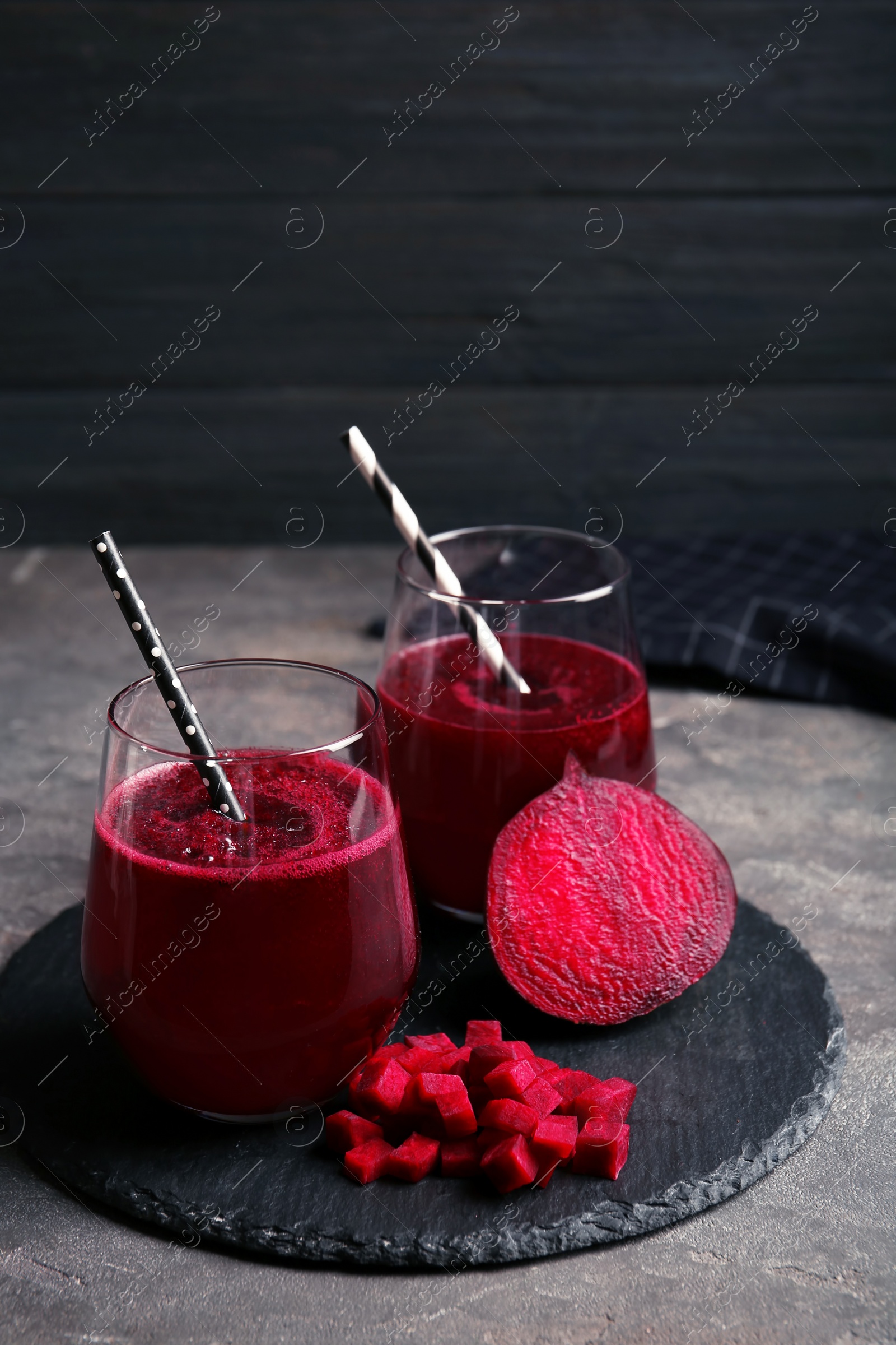 Photo of Slate plate with glasses of beet smoothies on table