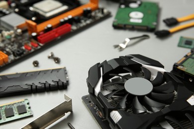 Photo of Graphics card and other computer hardware on gray background, closeup