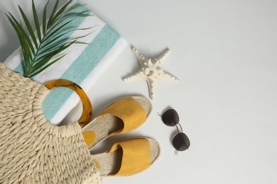 Composition with stylish beach accessories on white background, top view