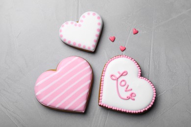 Decorated heart shaped cookies on grey table, flat lay. Valentine's day treat