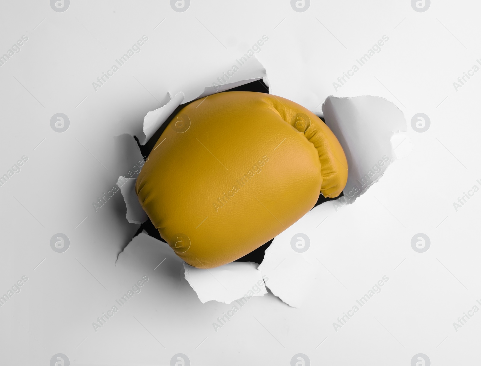 Image of Breaking through white paper with boxing glove